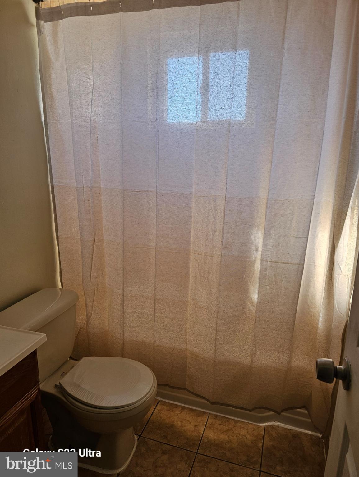 3855 28th Avenue, Unit 37 Temple Hills, MD 20748 - Photo 6 of 11 a bathroom with a toilet and a shower curtain