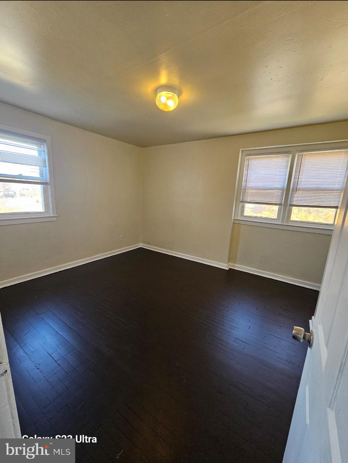 3855 28th Avenue, Unit 37 Temple Hills, MD 20748 - Photo 9 of 11 an empty room with wooden floor and windows