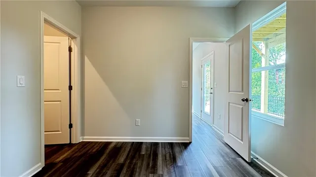 a view of a hallway with wooden floor and entryway