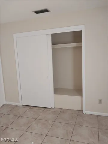 an empty room with white walls and windows