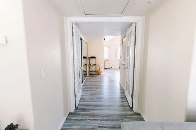 a bedroom with a bed and wooden floor