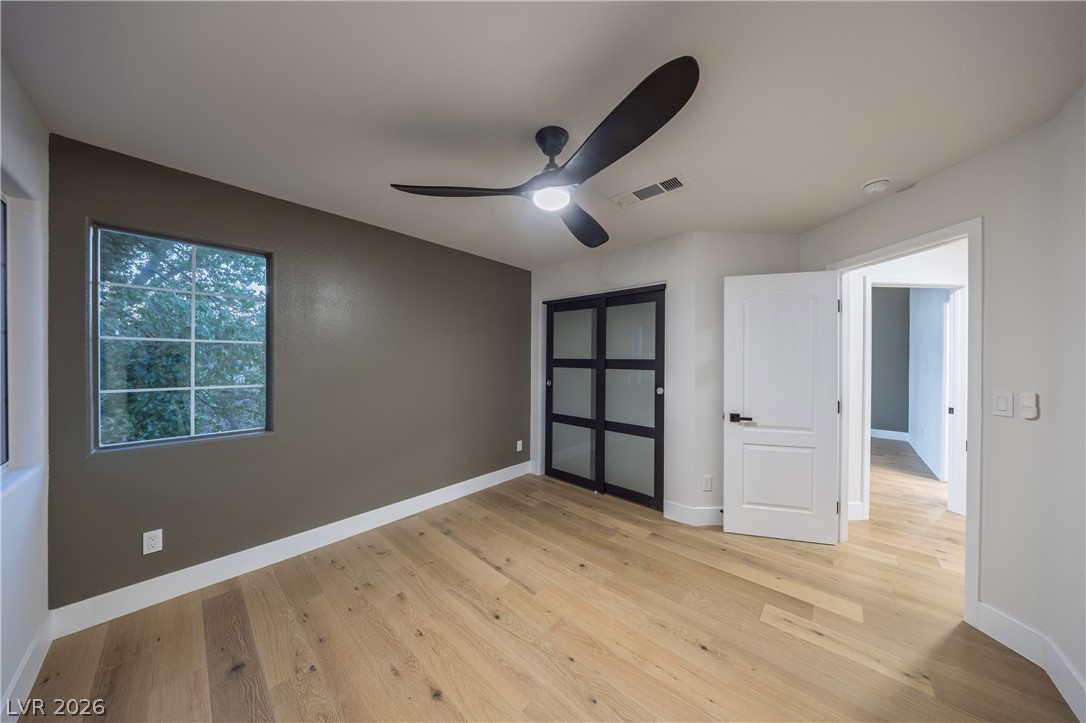8800 Lusso Las Vegas, NV 89134 - Photo 73 of 85 Unfurnished bedroom featuring light wood-style floors, ceiling fan, and a closet