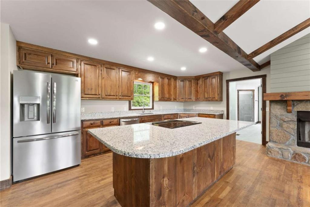 707 South Fern Cove Road Sautee Nacoochee, GA 30571 - Photo 13 of 60 a kitchen with stainless steel appliances granite countertop a refrigerator a sink dishwasher a stove and a refrigerator with wooden floor