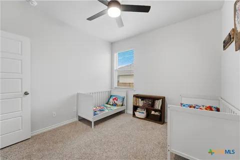 a children room with toys and a ceiling fan