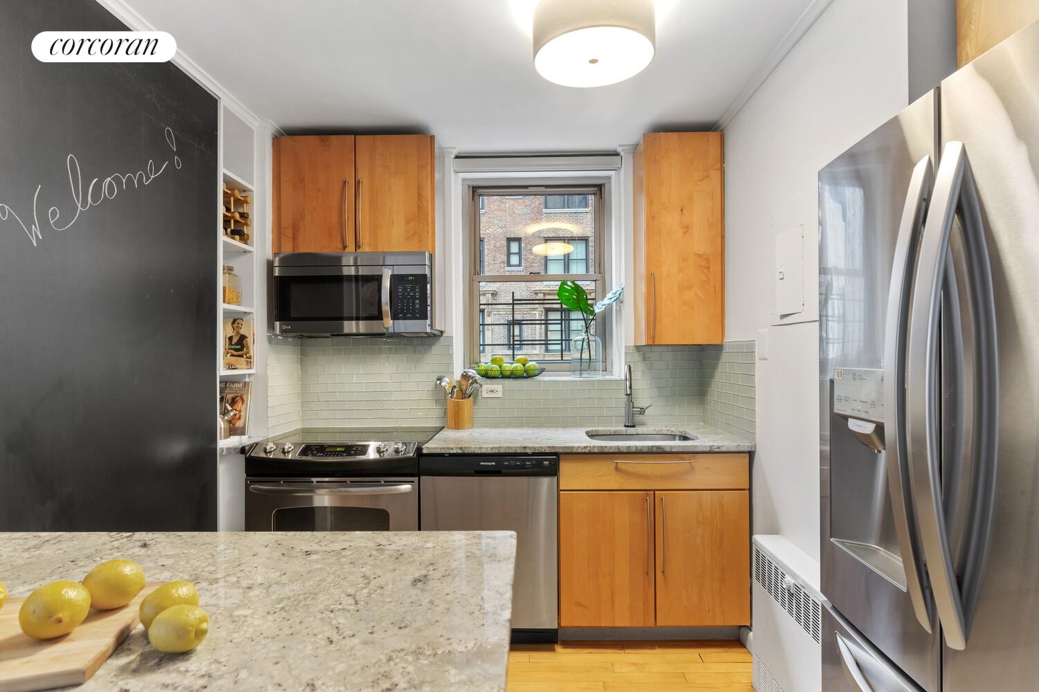 137 East 36th Street, Unit 3G Manhattan, NY 10016 - Photo 6 of 14 a kitchen with stainless steel appliances granite countertop a sink stove and refrigerator