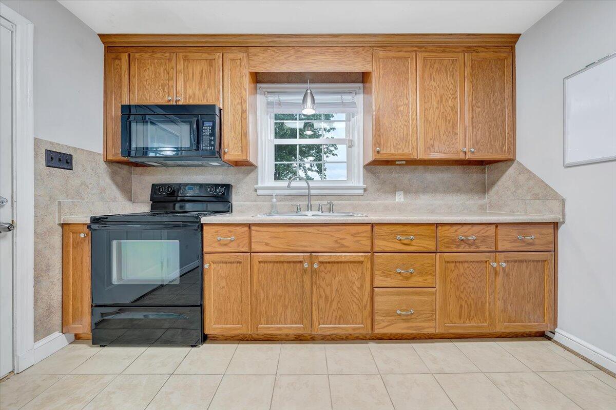 2423 Bluff Road Roanoke, VA 24014 - Photo 5 of 21 a kitchen with granite countertop a stove a sink and a microwave