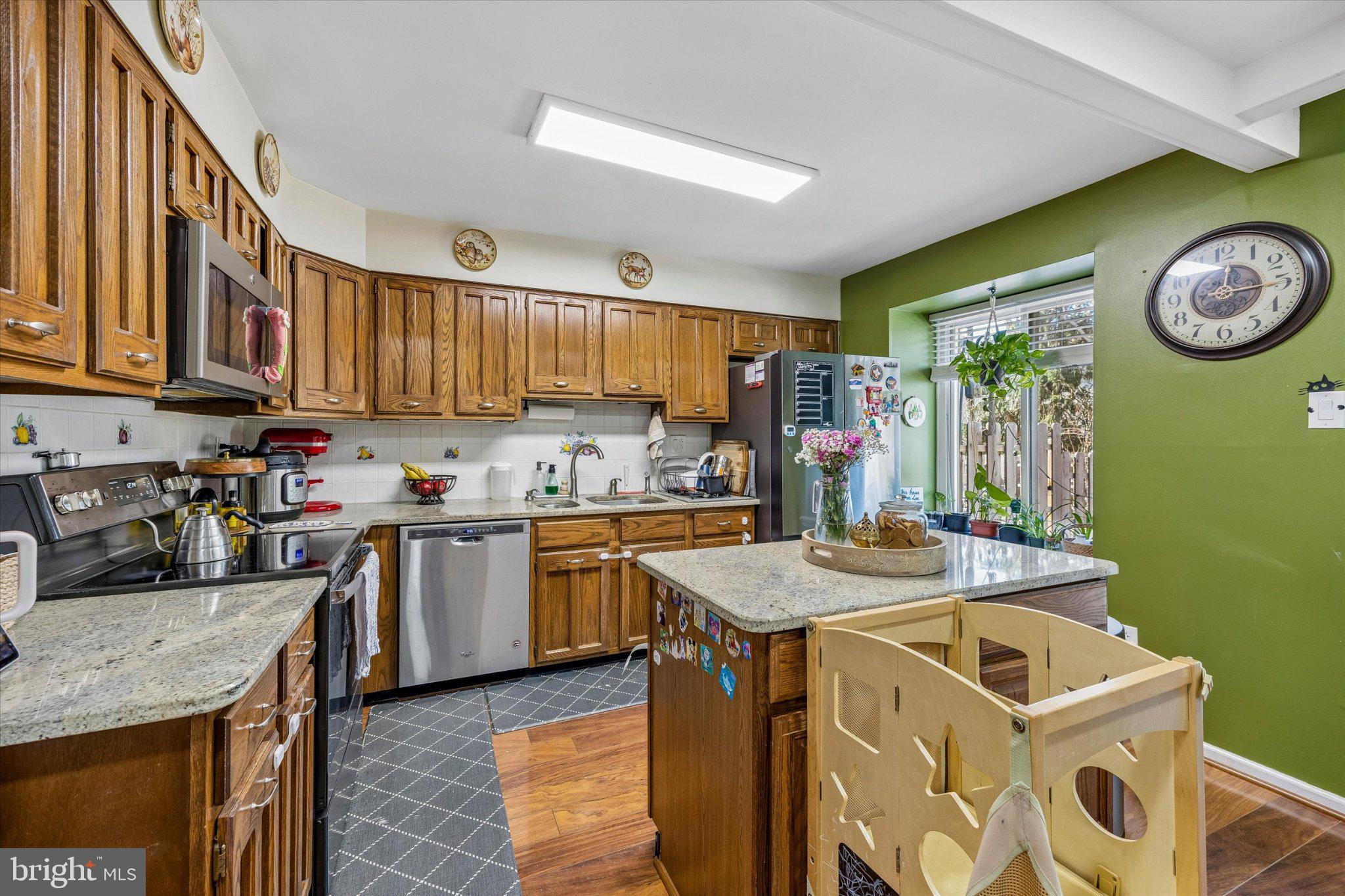 24 Independence Place Newtown, PA 18940 - Photo 6 of 15 a kitchen with a sink a stove top oven a clock and a window