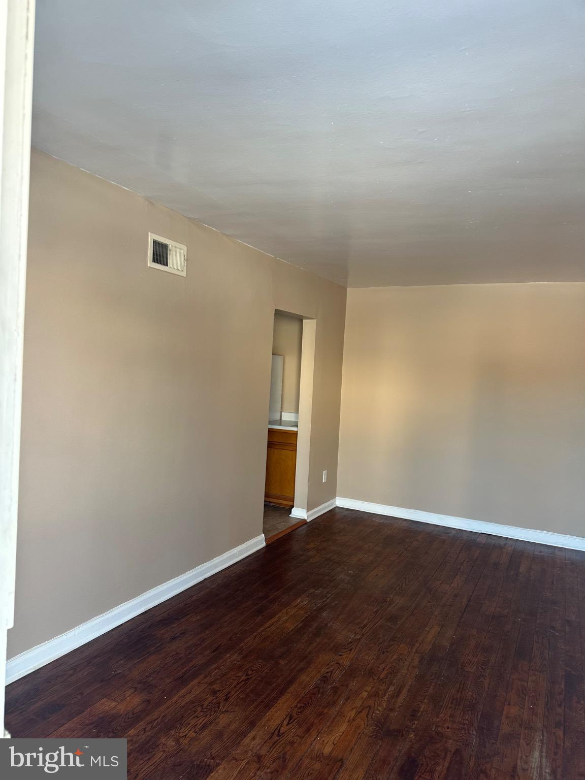 1449 Olive Street Northeast, Unit 4 Washington, DC 20019 - Photo 18 of 19 Spacious room with warm, inviting tones.