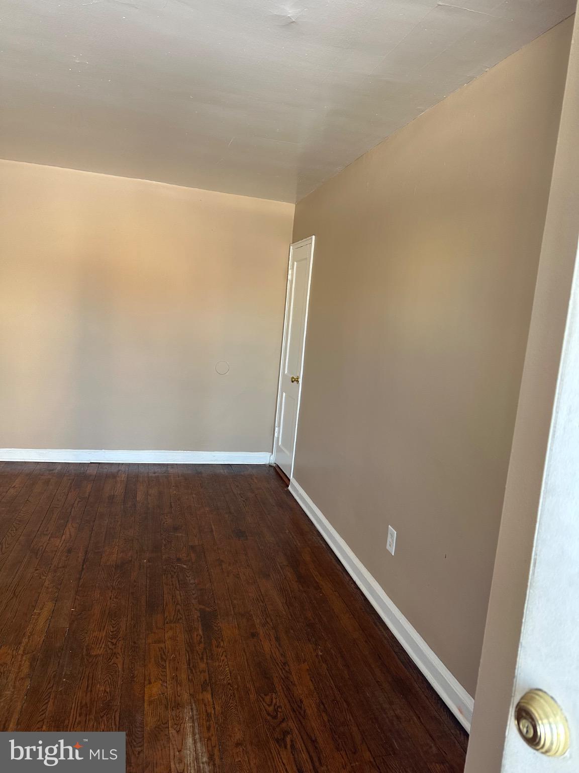 1449 Olive Street Northeast, Unit 4 Washington, DC 20019 - Photo 19 of 19 Spacious room with warm, inviting tones.