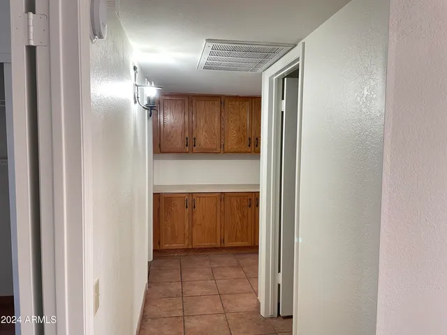 a view of hallway with cabinets