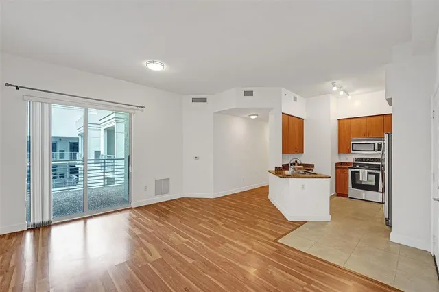 a large bedroom with a bed and wooden floor