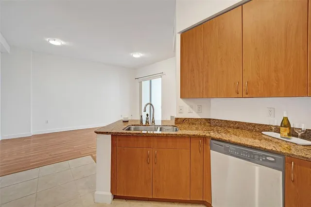 a kitchen with stainless steel appliances granite countertop a sink stove and cabinets