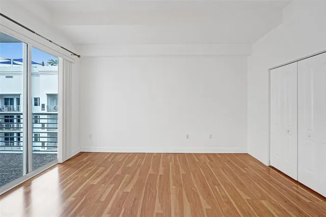 a view of a room with wooden floor and fence