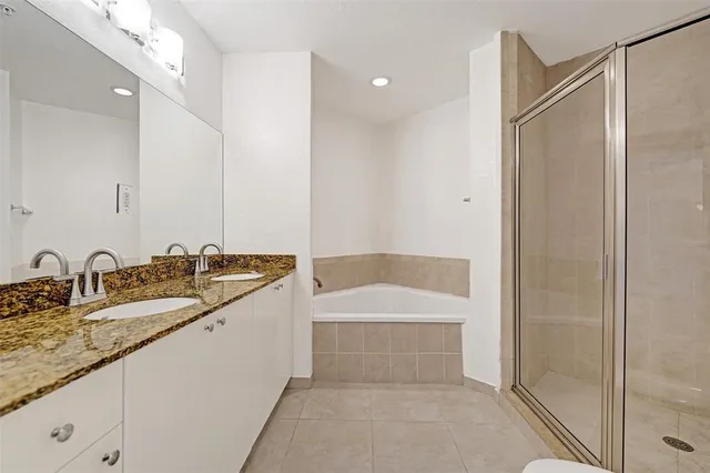 a bathroom with a granite countertop sink mirror and double