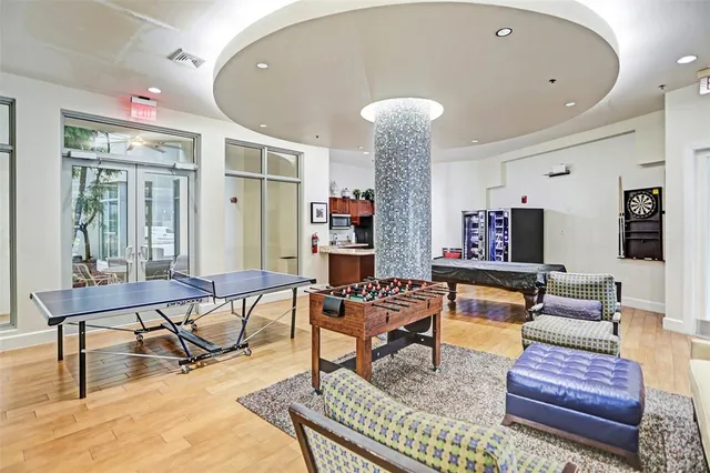 a living room filled with lots of furniture and wooden floor