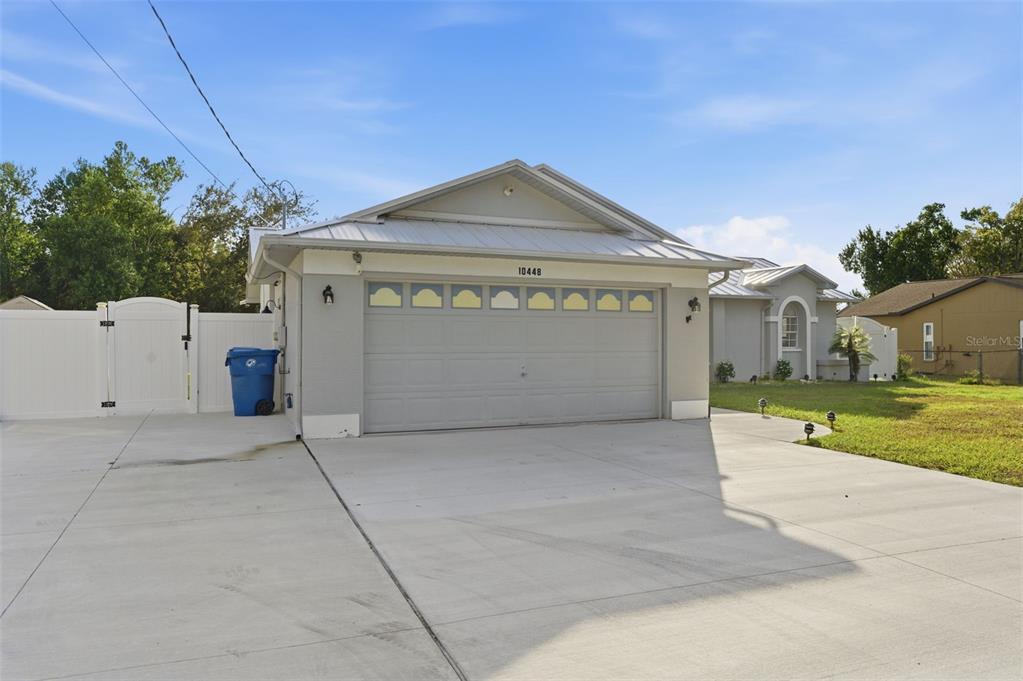 10448 Utah Street Spring Hill, FL 34608 - Photo 11 of 54 a front view of a house with a yard and garage