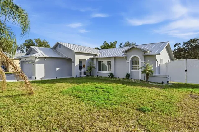 a living room with lots of furniture and view of kitchen