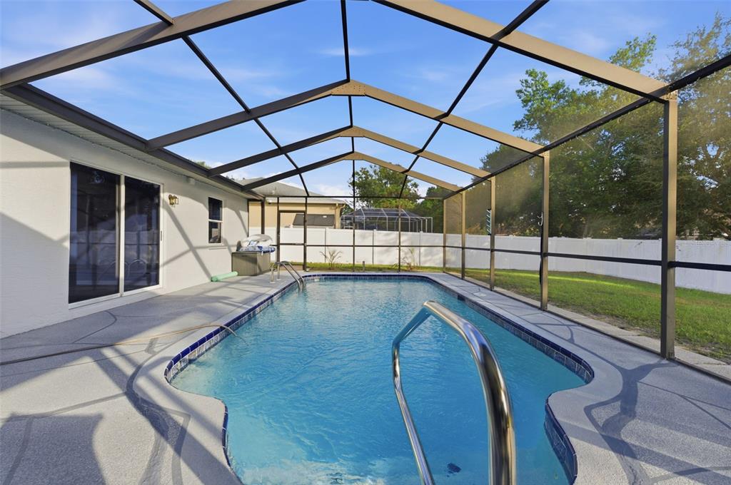 10448 Utah Street Spring Hill, FL 34608 - Photo 15 of 54 a view of a backyard with a swimming pool