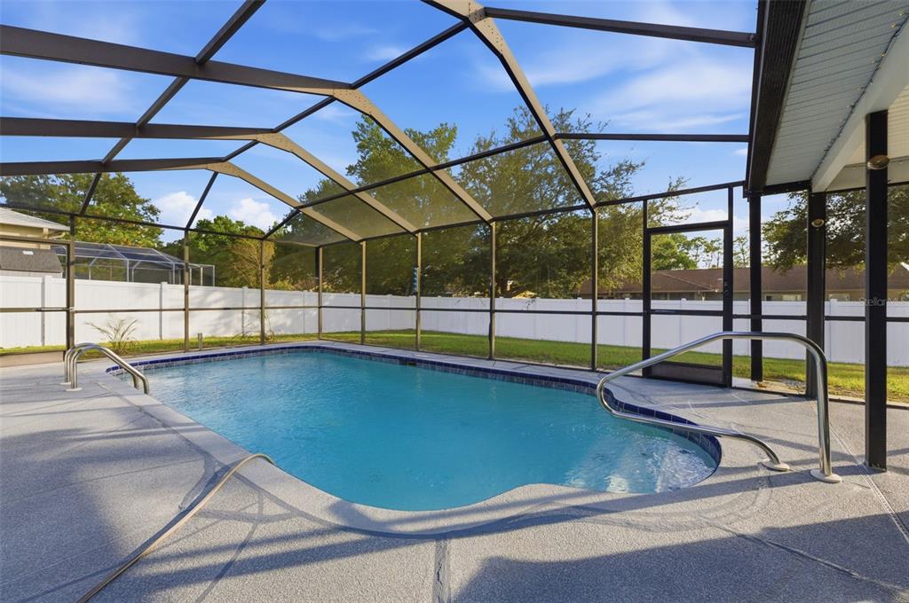 10448 Utah Street Spring Hill, FL 34608 - Photo 16 of 54 a view of a swimming pool with a porch