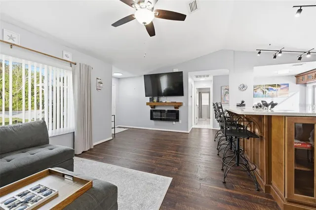 a bedroom with a large bed and a flat tv screen on dresser