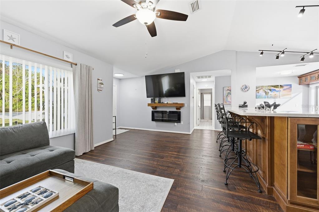 10448 Utah Street Spring Hill, FL 34608 - Photo 25 of 54 a living room with furniture and a flat screen tv