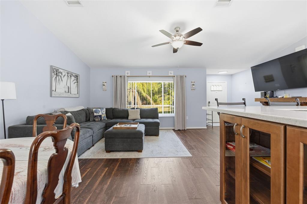 10448 Utah Street Spring Hill, FL 34608 - Photo 27 of 54 a living room with furniture a window and a flat screen tv