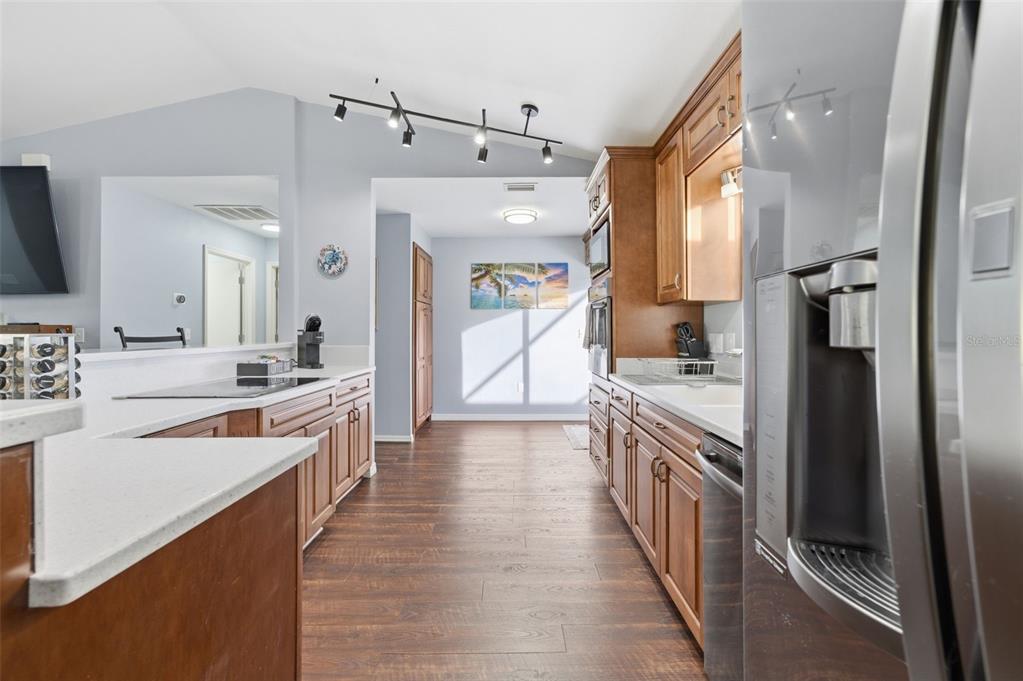 10448 Utah Street Spring Hill, FL 34608 - Photo 29 of 54 a large kitchen with stainless steel appliances a sink and a refrigerator