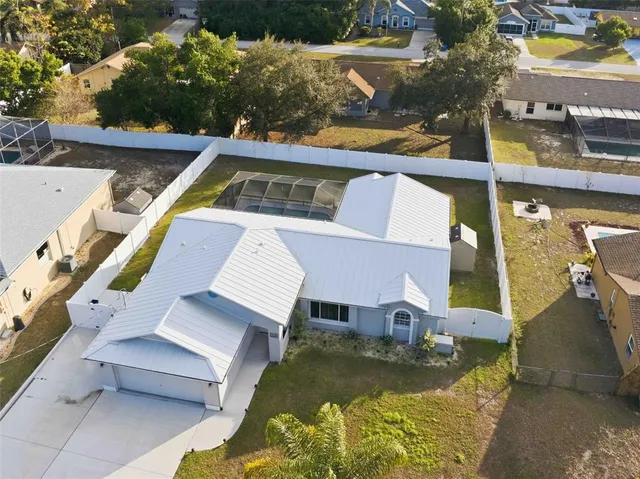 an aerial view of a house with swimming pool