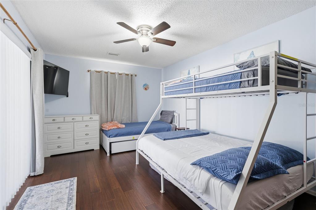 10448 Utah Street Spring Hill, FL 34608 - Photo 37 of 54 a bedroom with furniture and a flat screen tv