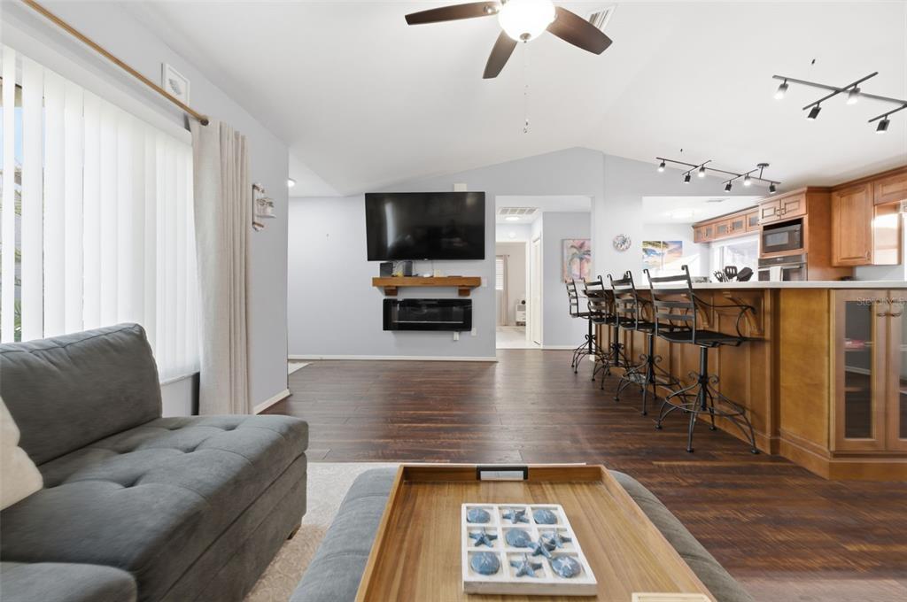 10448 Utah Street Spring Hill, FL 34608 - Photo 44 of 54 a living room with furniture and a flat screen tv