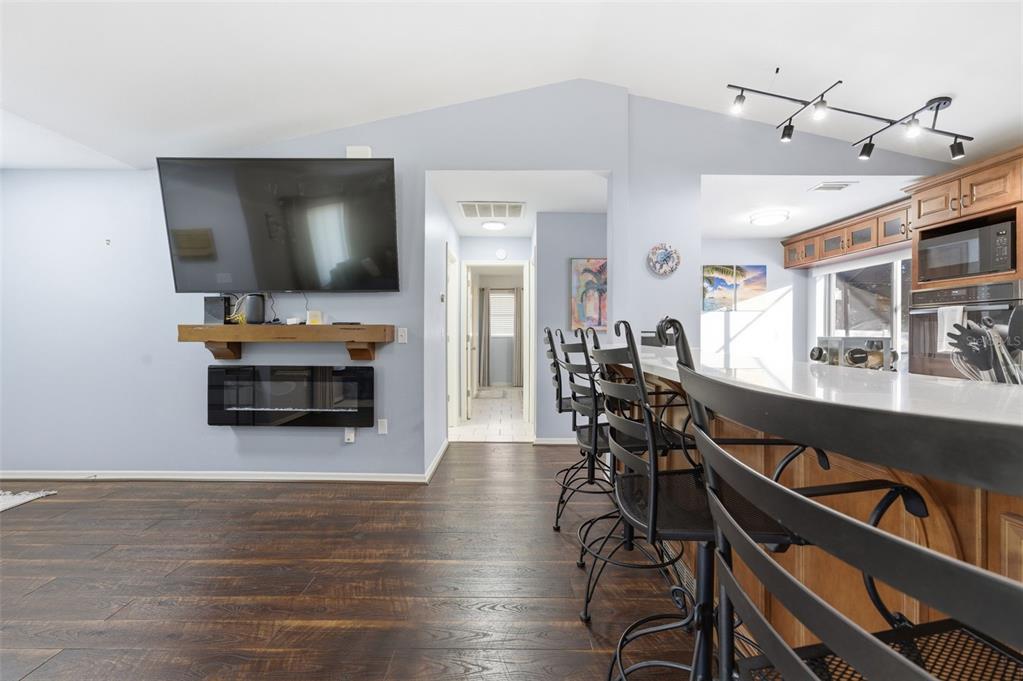 10448 Utah Street Spring Hill, FL 34608 - Photo 45 of 54 a living room with furniture and a flat screen tv