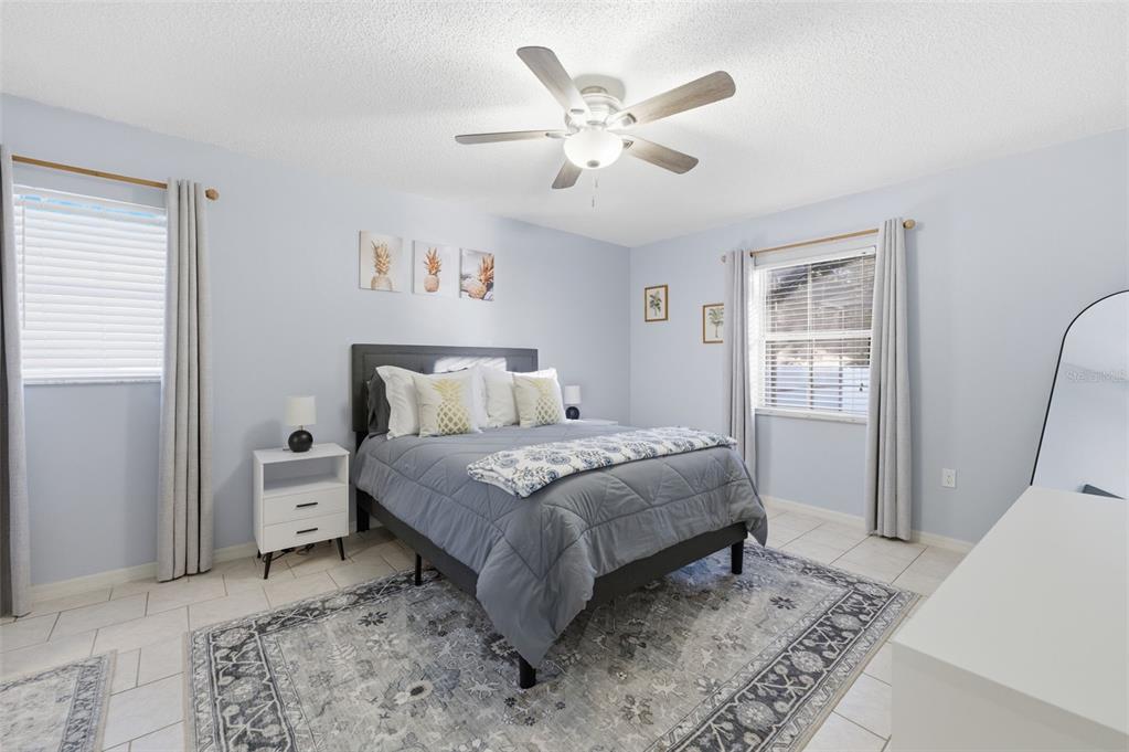 10448 Utah Street Spring Hill, FL 34608 - Photo 47 of 54 a bedroom with a bed and a chandelier