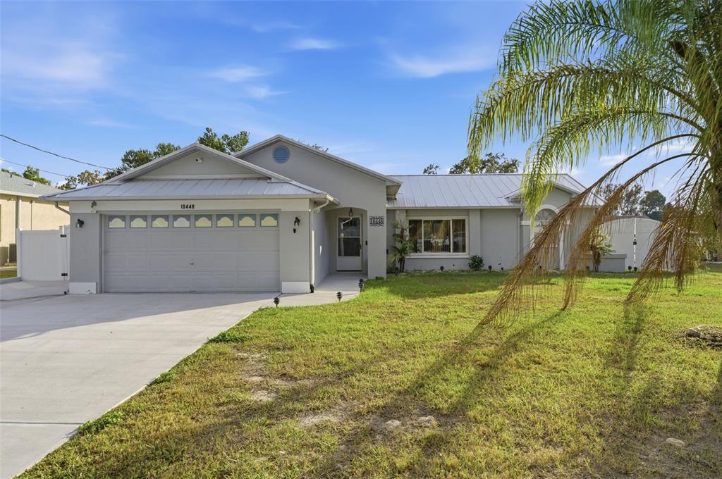 10448 Utah Street Spring Hill, FL 34608 - Photo 10 of 54 a front view of a house with garden