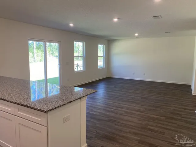 a kitchen with granite countertop cabinets stainless steel appliances and a counter tops