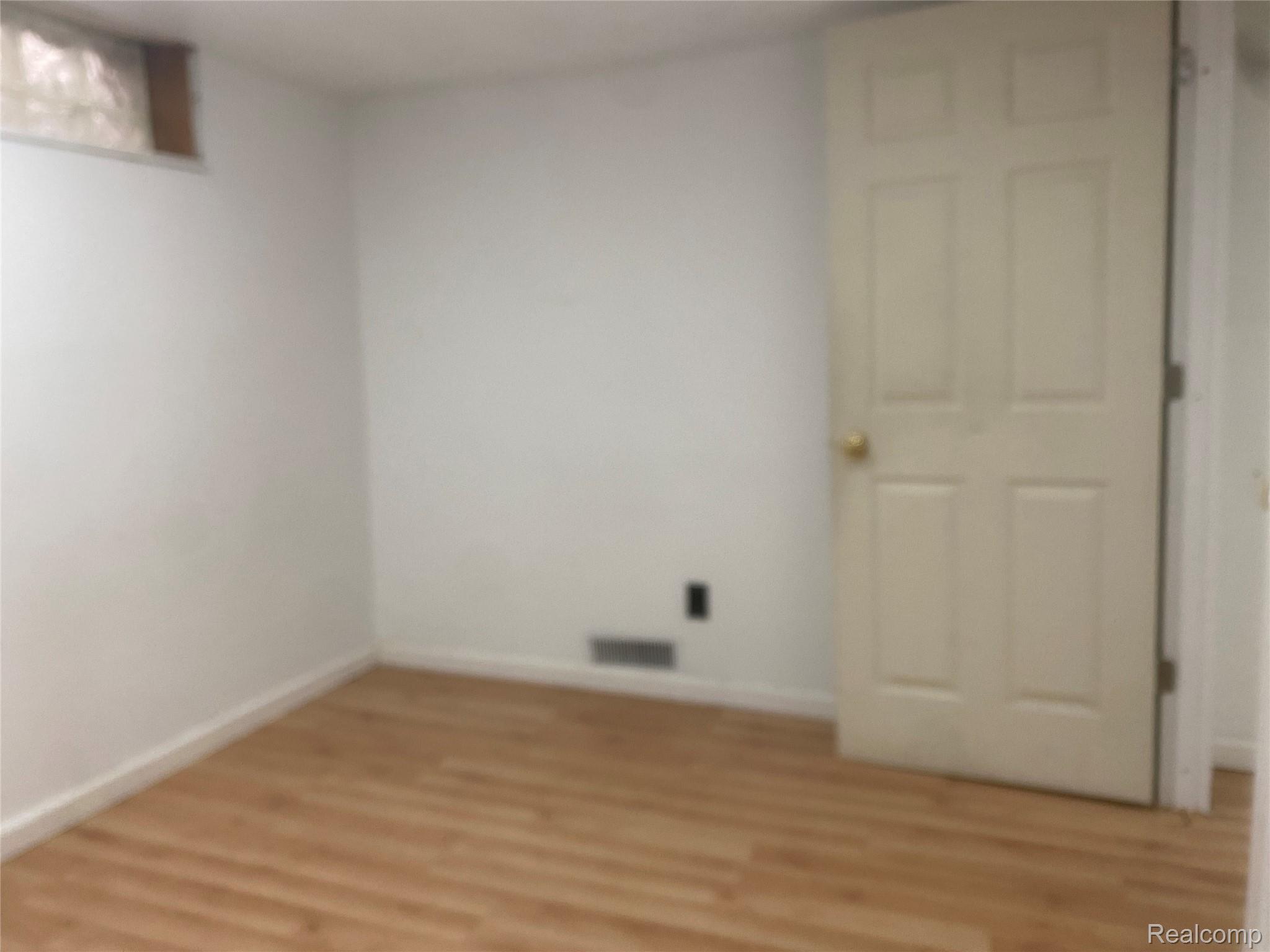180 West Rutgers Avenue Pontiac, MI 48340 - Photo 26 of 33 Unfurnished room featuring light wood-style floors and baseboards