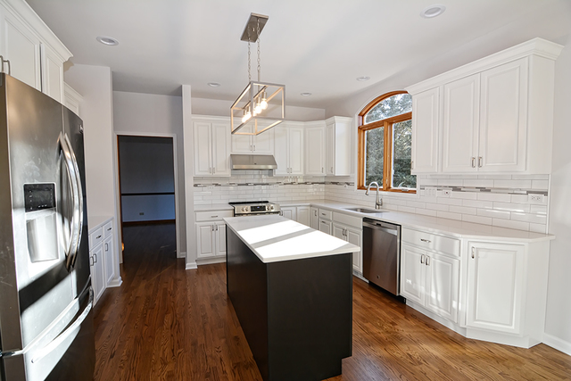 39W203 Cranston Road St. Charles, IL 60175 - Photo 8 of 36 a kitchen with stainless steel appliances granite countertop a refrigerator a sink dishwasher a stove and white countertops with wooden floor
