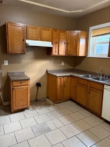 a kitchen with stainless steel appliances a stove a sink and a microwave