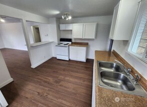 12524 Addison Street Southwest Lakewood, WA 98499 - Photo 14 of 17 a kitchen with granite countertop a sink and a stove top oven
