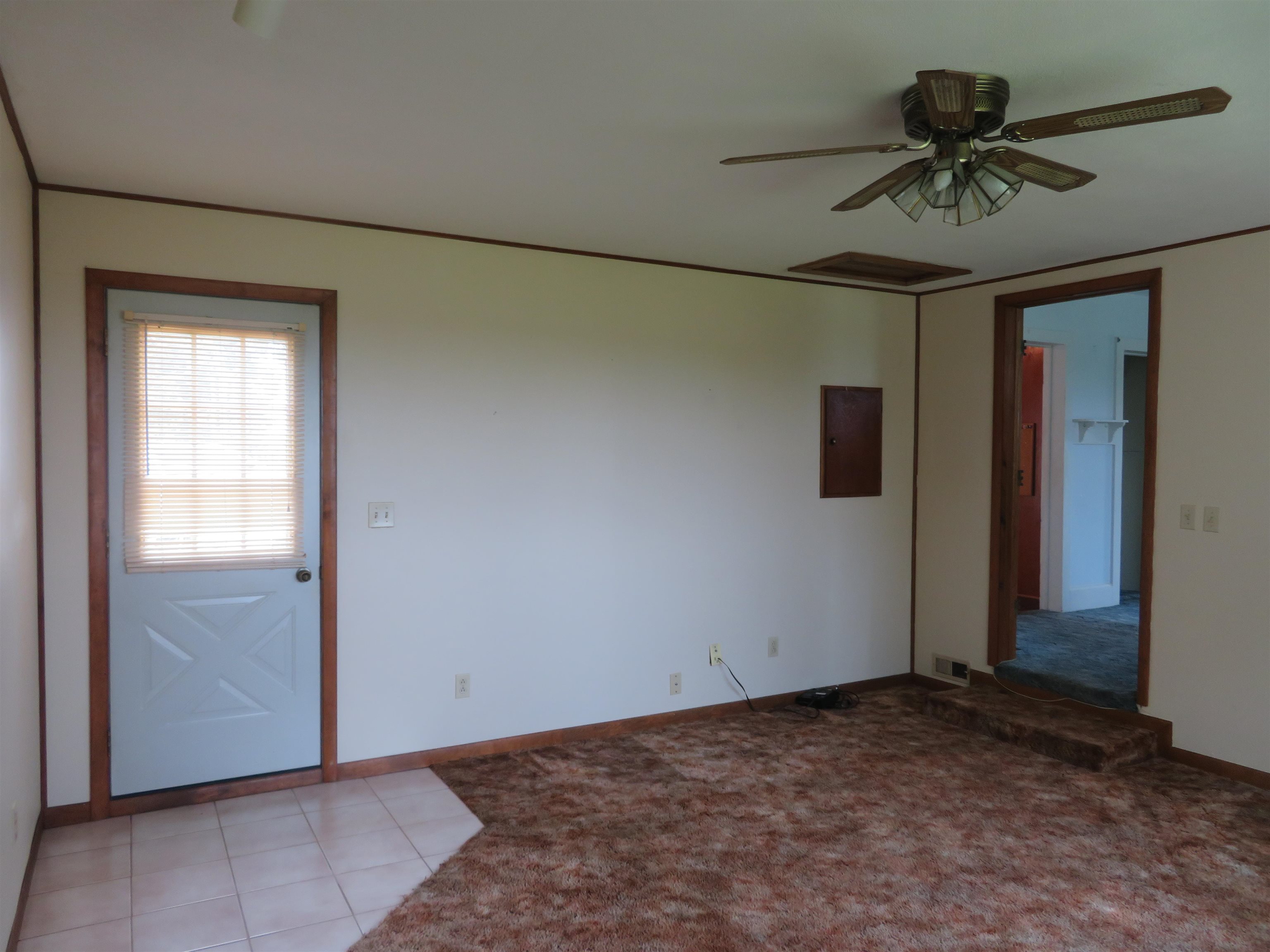 6940 West Stephenson St Road Freeport, IL 61032 - Photo 4 of 25 a view of a livingroom with a ceiling fan and carpet