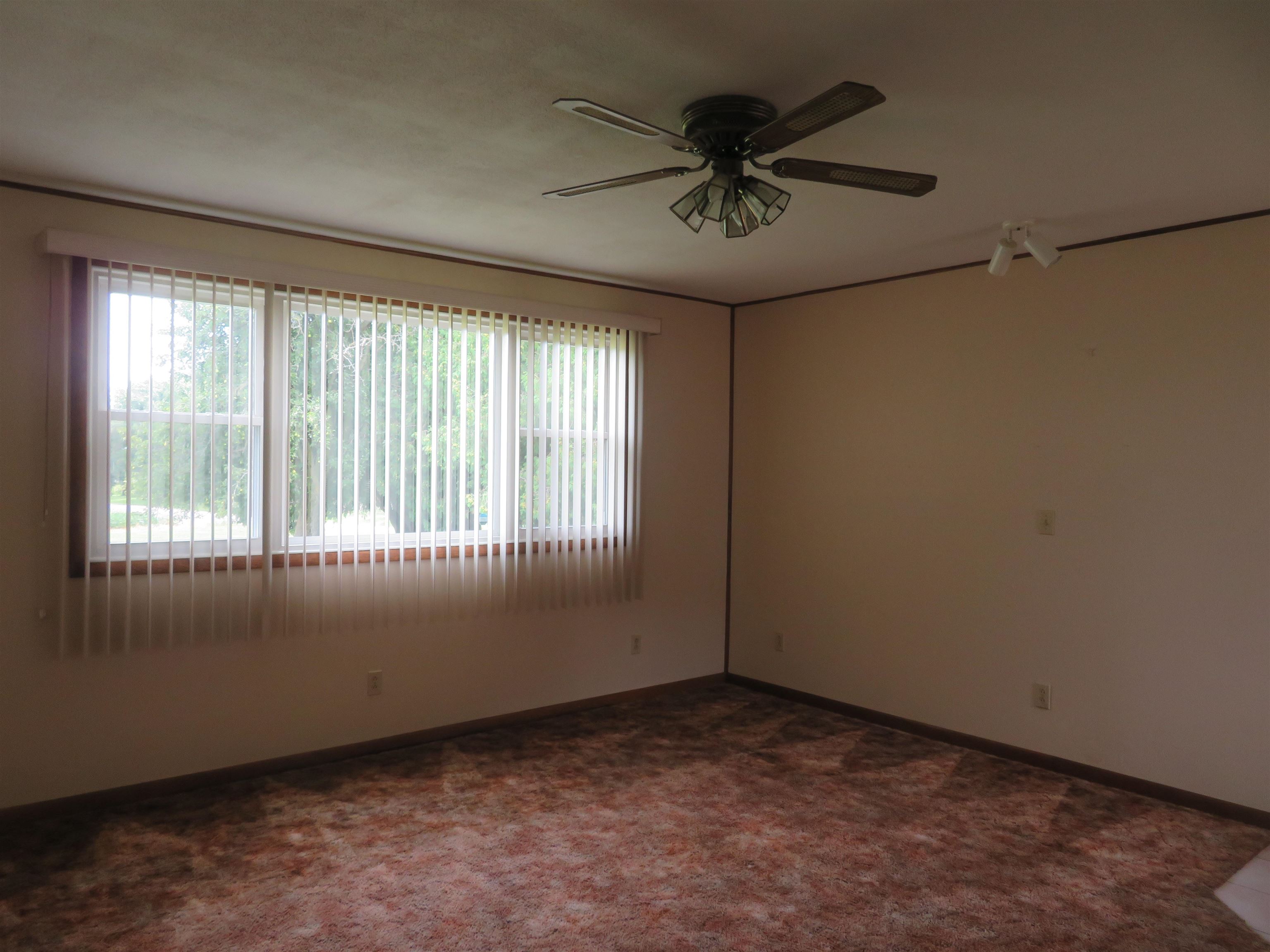 6940 West Stephenson St Road Freeport, IL 61032 - Photo 5 of 25 a view of an empty room and chandelier fan