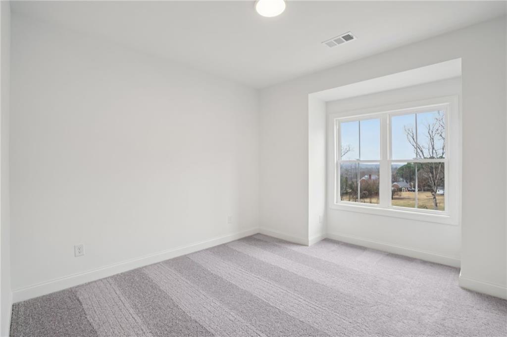 653 Silva Street, Unit 139 Cumming, GA 30040 - Photo 22 of 47 an empty room with a window
