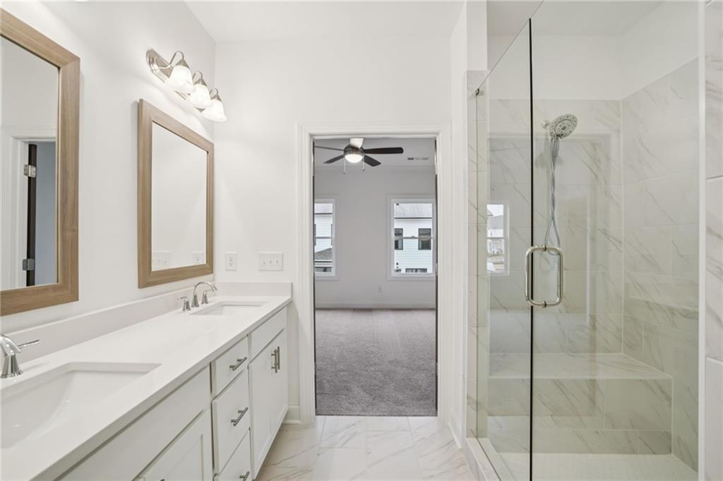 653 Silva Street, Unit 139 Cumming, GA 30040 - Photo 29 of 47 a spacious bathroom with a double vanity sink mirror and double