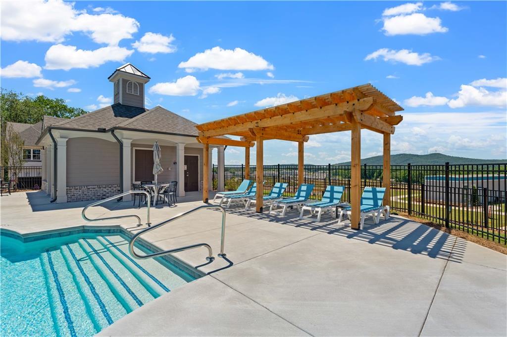 653 Silva Street, Unit 139 Cumming, GA 30040 - Photo 46 of 47 a view of a patio with a table and chairs