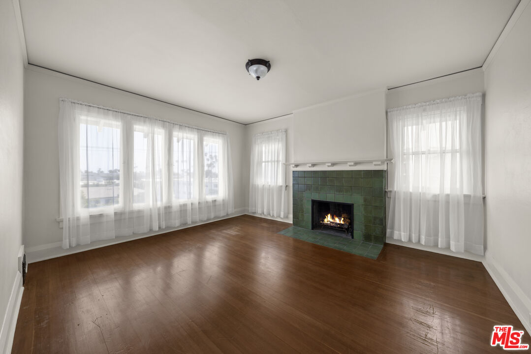 2027 3rd Street Santa Monica, CA 90405 - Photo 12 of 17 a view of an empty room with wooden floor fireplace and a window