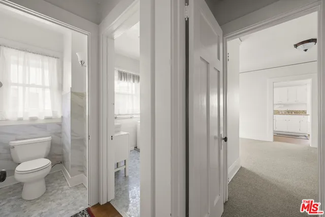 a bathroom with a toilet shower and a sink