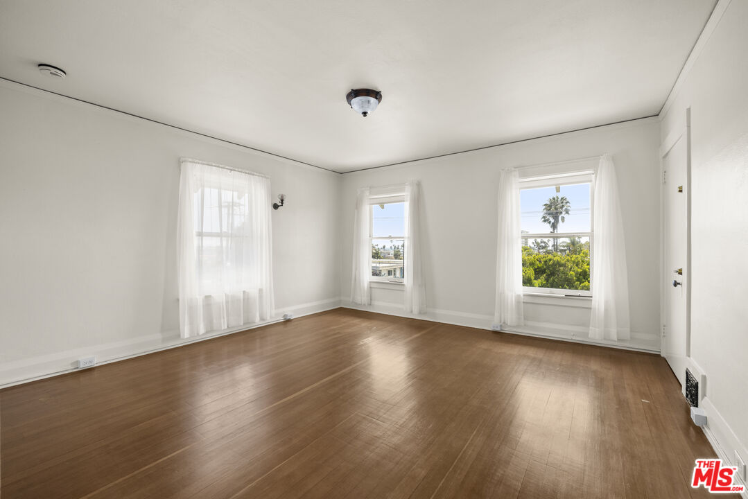 2027 3rd Street Santa Monica, CA 90405 - Photo 7 of 17 an empty room with wooden floor and windows