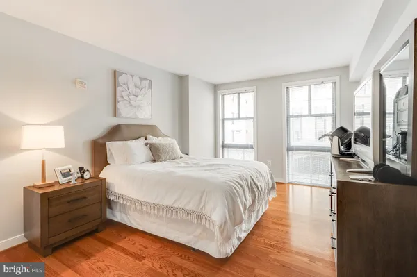 a bedroom with a bed and wooden floor