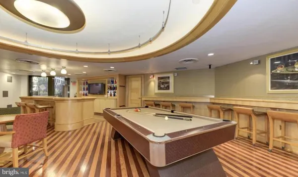 a kitchen with a sink appliances and a dining table