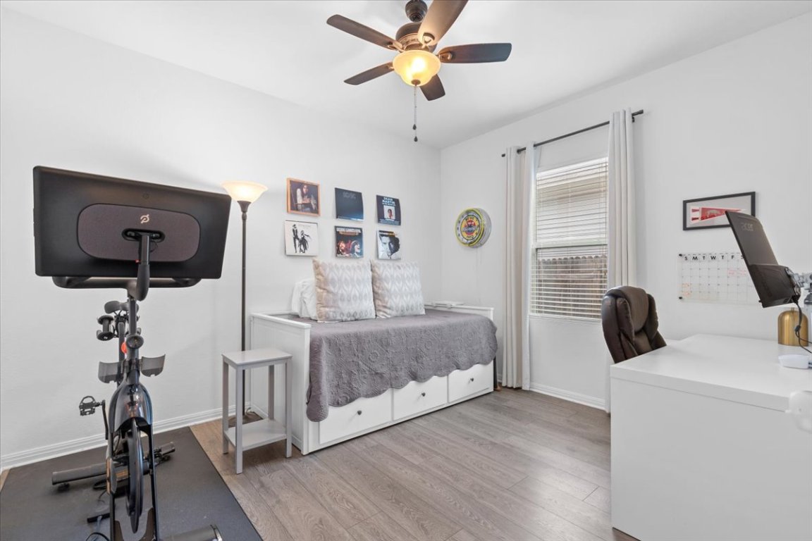 19305 Nathan Scott Way Manor, TX 78653 - Photo 15 of 18 a bedroom with a bed and a flat tv screen