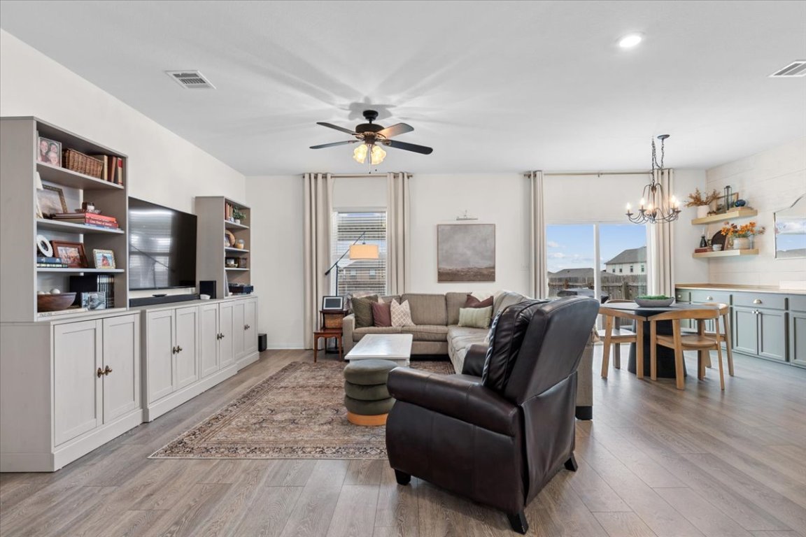 19305 Nathan Scott Way Manor, TX 78653 - Photo 5 of 18 a living room with furniture a flat screen tv and a wooden floor